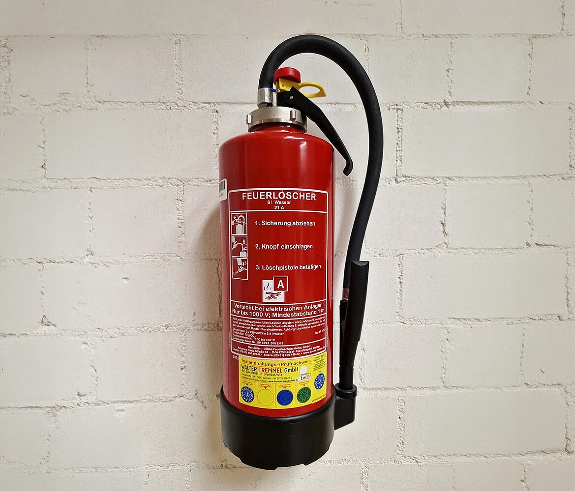 Ein Feuerlöscher, der an der Wand befestigt ist